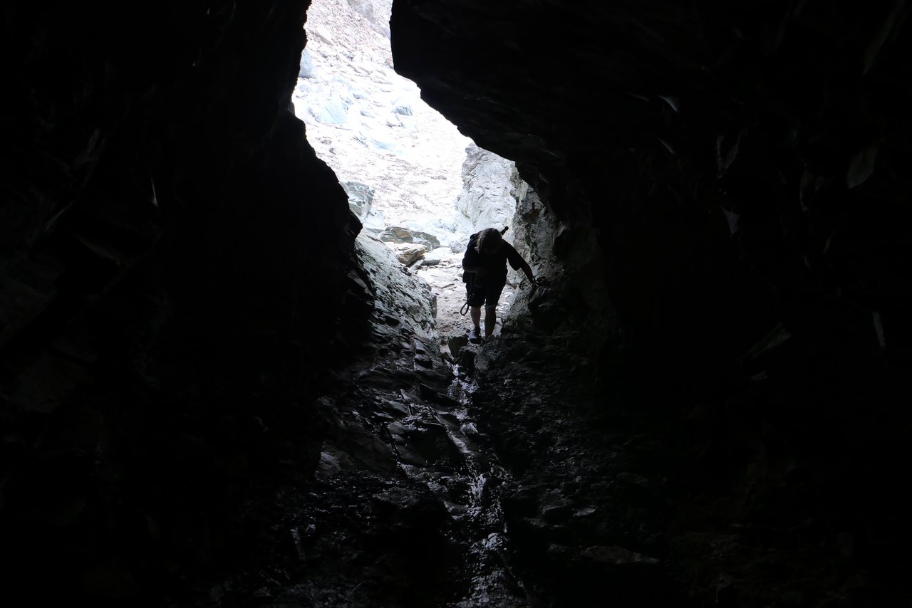 Cave Mouth. A figure climbing out of the dark towards the light.