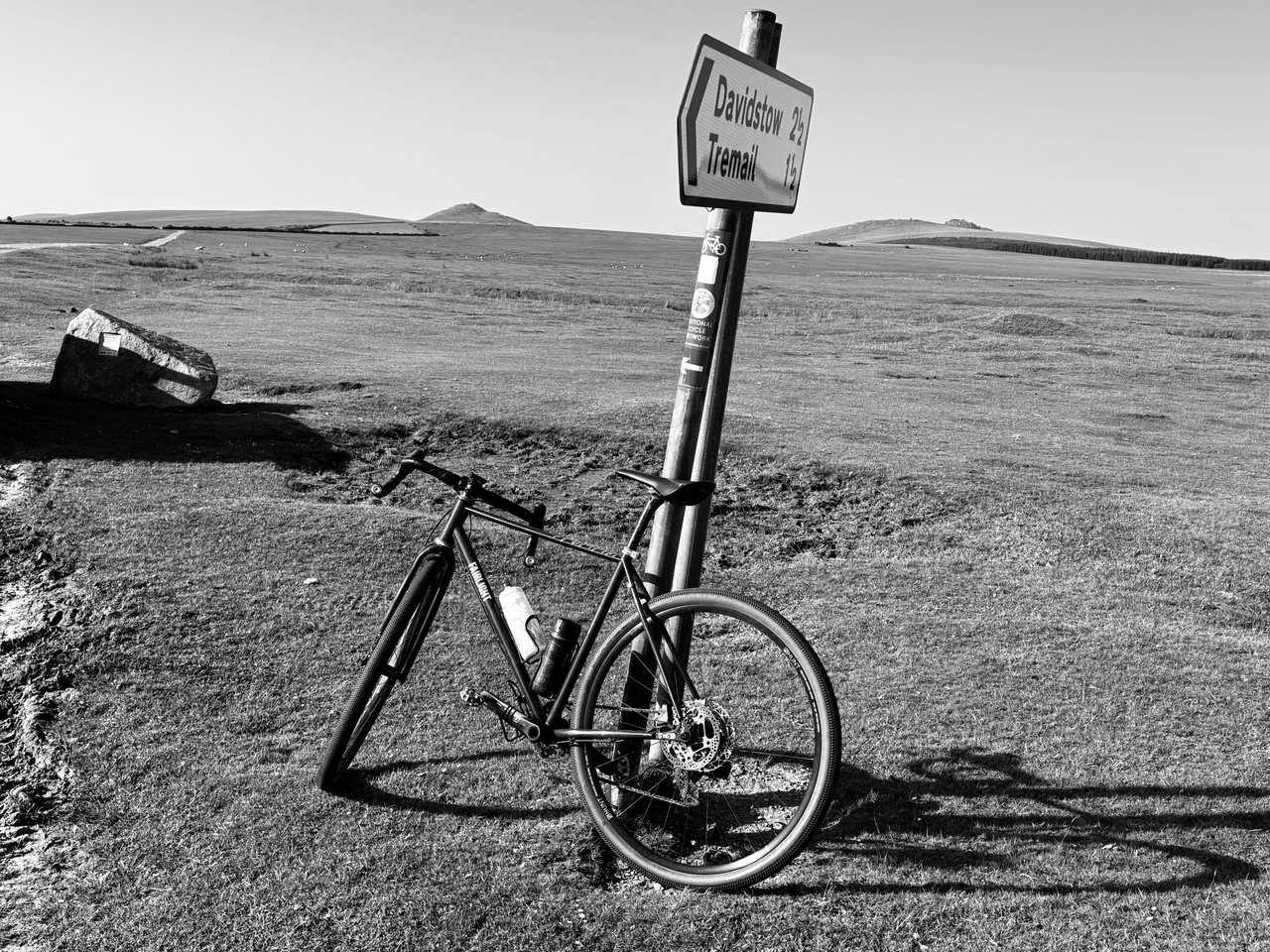 Davidstow. A bike against the signpost, open moor all around.