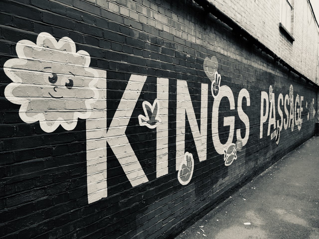 Kings Passage. A painted sign on a brick wall.
