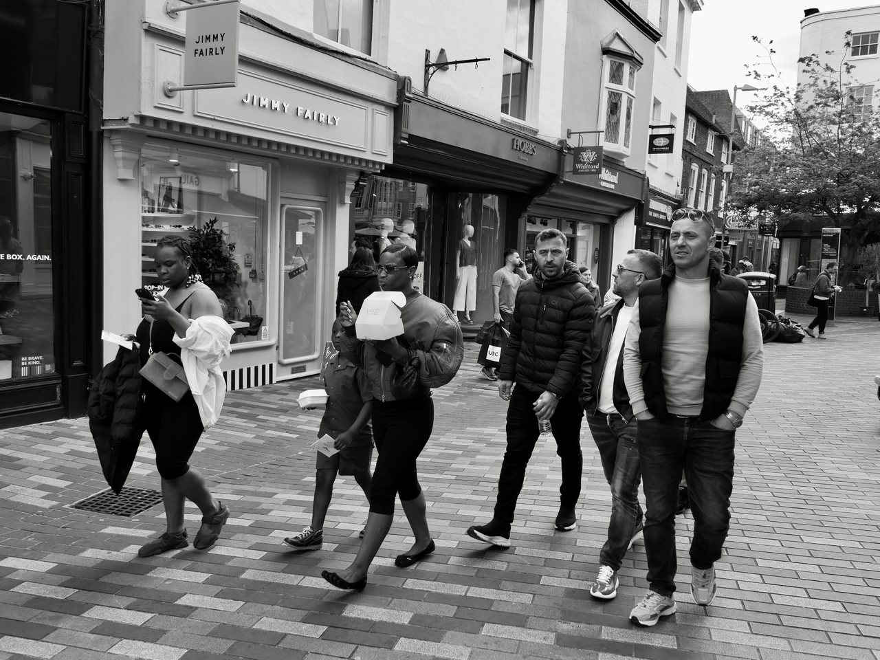Passing Through. People walking through town, each on their own way.