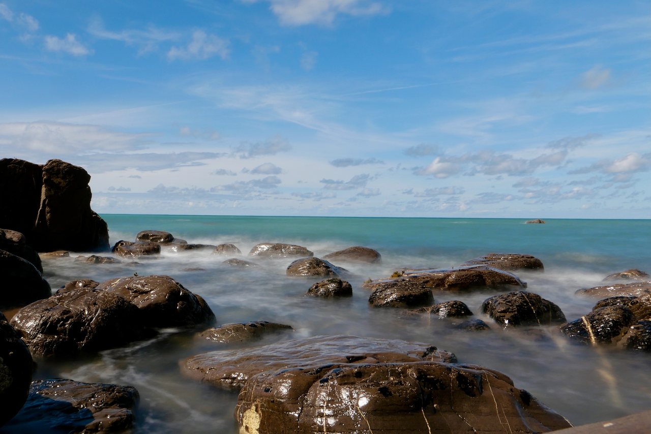 Slow Water I. The sea blurred around the rocks by a long exposure.